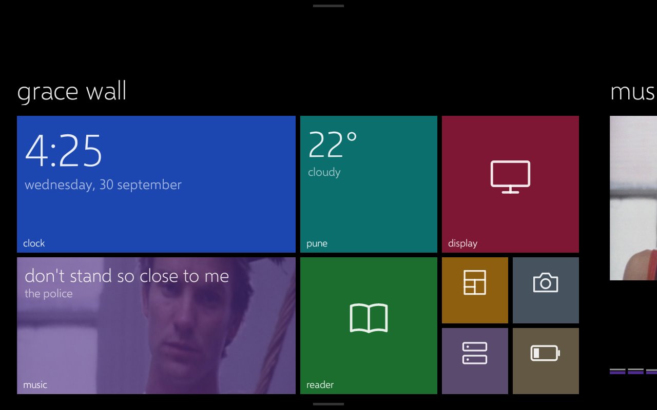The tablet's home screen: Windows Phone style live tiles for the clock, weather, display, now playing, reader and status.